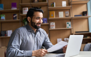 When the "Imperfect" Candidate Becomes the Best Hire 10 Smiling indian business man hr employer, teacher or lawyer holding cv document having virtual job interview meeting by video conference call, consulting client on laptop at online legal advice.